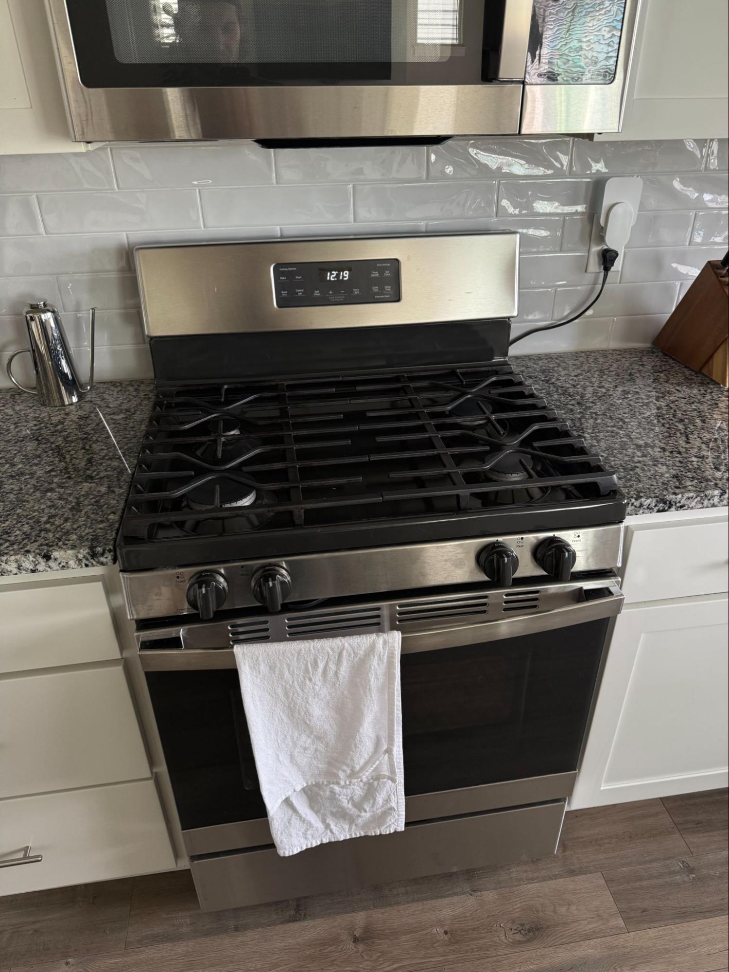 GE JGB645SEK3SS gas range inspected for a continuously clicking igniter in Camas, Washington